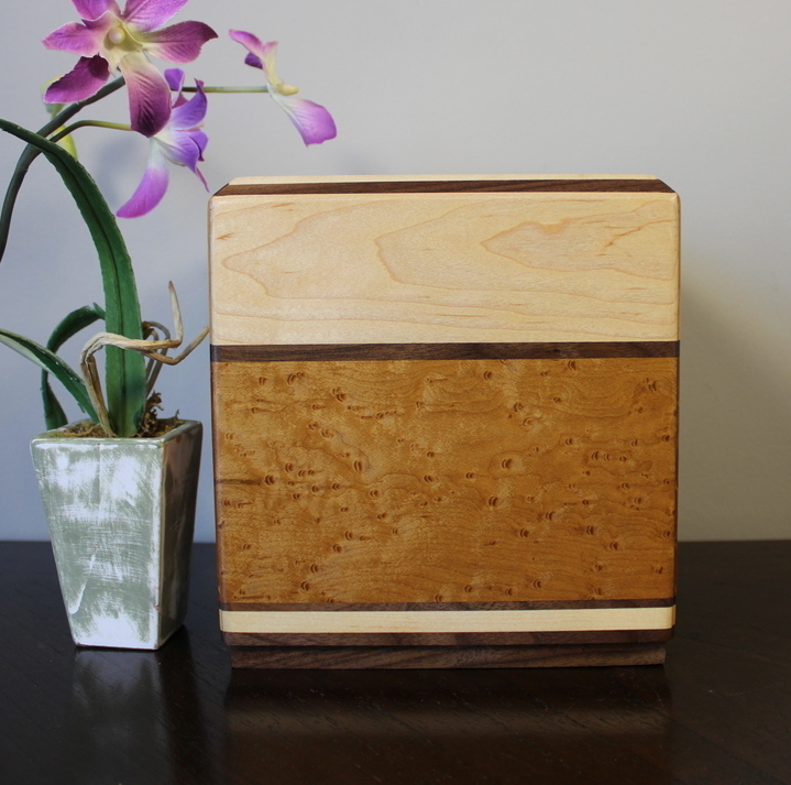 Back view of a light maple and torrefied bird's eye maple wooden cremation urn