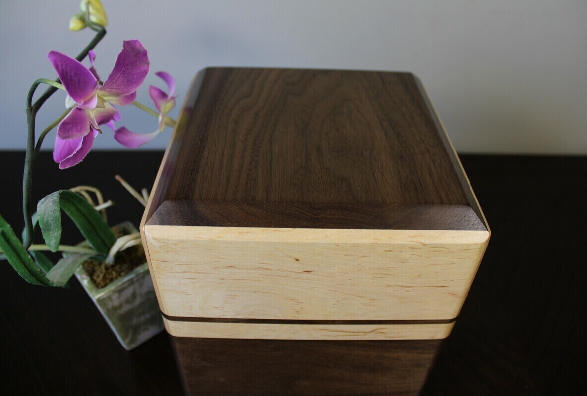 Top view of a Black walnut and maple with subtle speckles wooden cremation urn