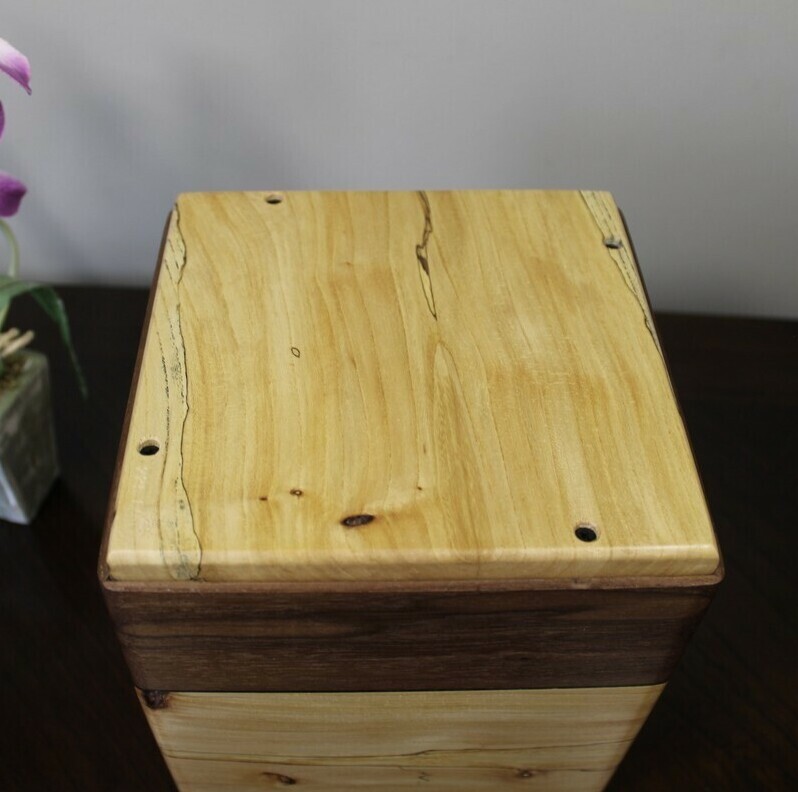 Bottom view of a spalted elm and black walnut wooden cremation urn