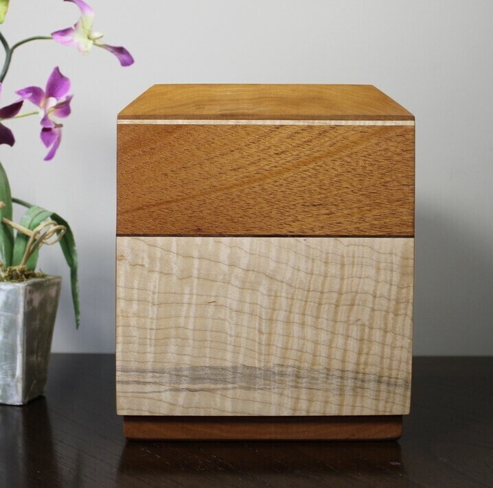 Back view of a cherry, mahogany and curly maple wooden cremation urn