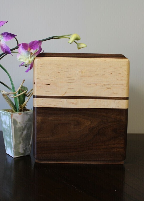 Back view of a Black walnut and maple with subtle speckles wooden cremation urn