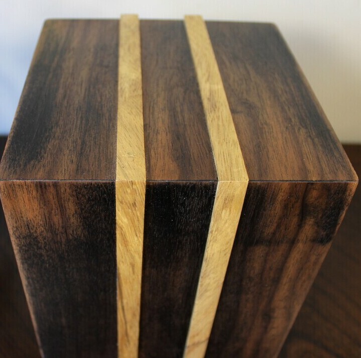 Top view of an ebonized black walnut and White Limba strips wooden cremation urn