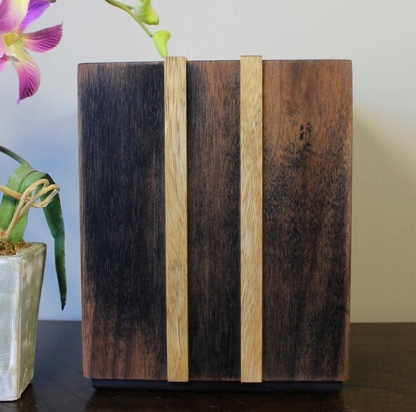 Front view of an ebonized black walnut and White Limba strips wooden cremation urn