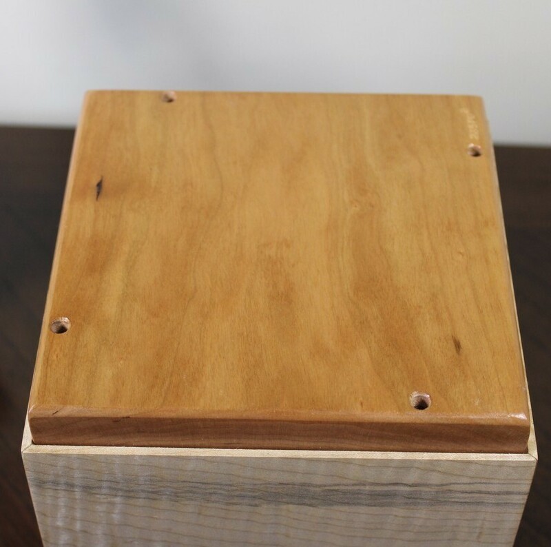 Bottom view of a cherry, mahogany and curly maple wooden cremation urn