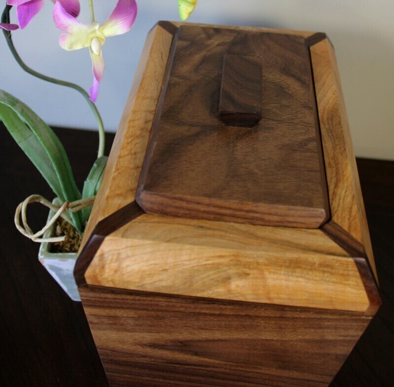 Alternate top view of a black walnut and figured maple wooden cremation urn with receptacle