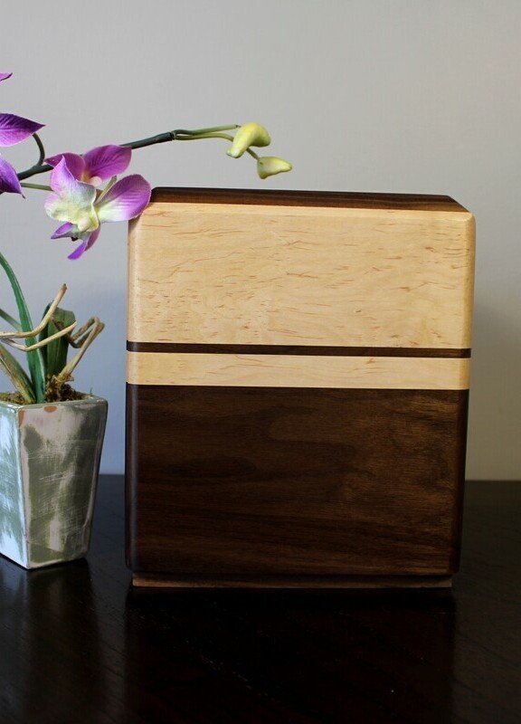 Right side view of a Black walnut and maple with subtil speckles wooden cremation urn