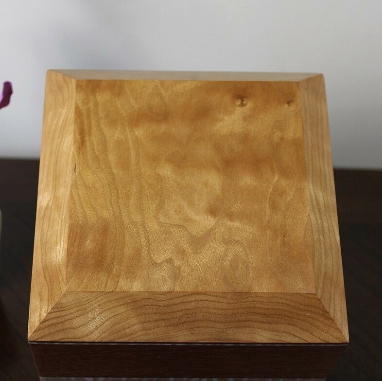 Top view of a cherry, mahogany and curly maple wooden cremation urn