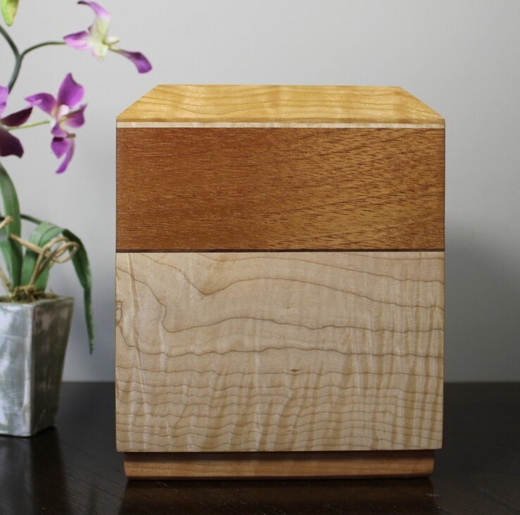 Right side view of a cherry, mahogany and curly maple wooden cremation urn