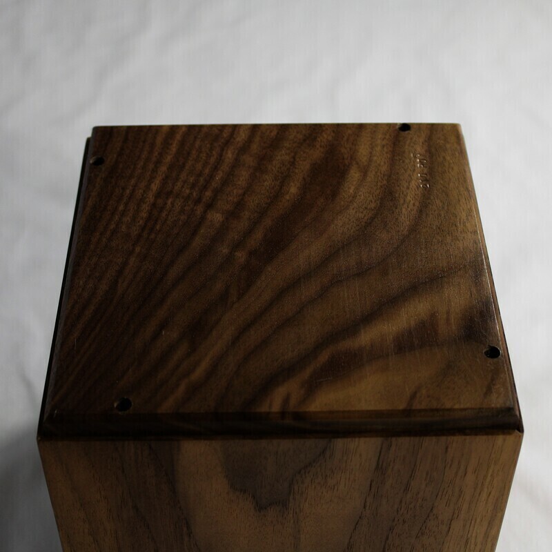 Bottom view of a boldly striped black Walnut wooden cremation urn