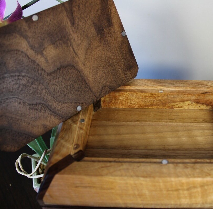 Alternate receptable view of a black walnut and figured maple wooden cremation urn