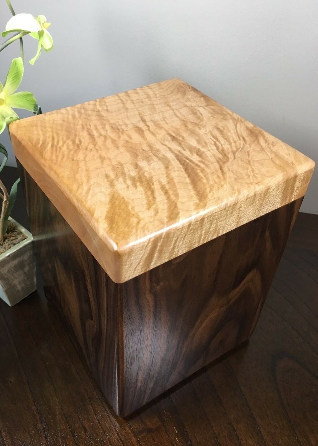 Top view of a black walnut and flamed maple wooden cremation urn